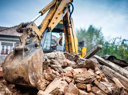 Hydraulic crusher excavator backoe machinery working on site demolition